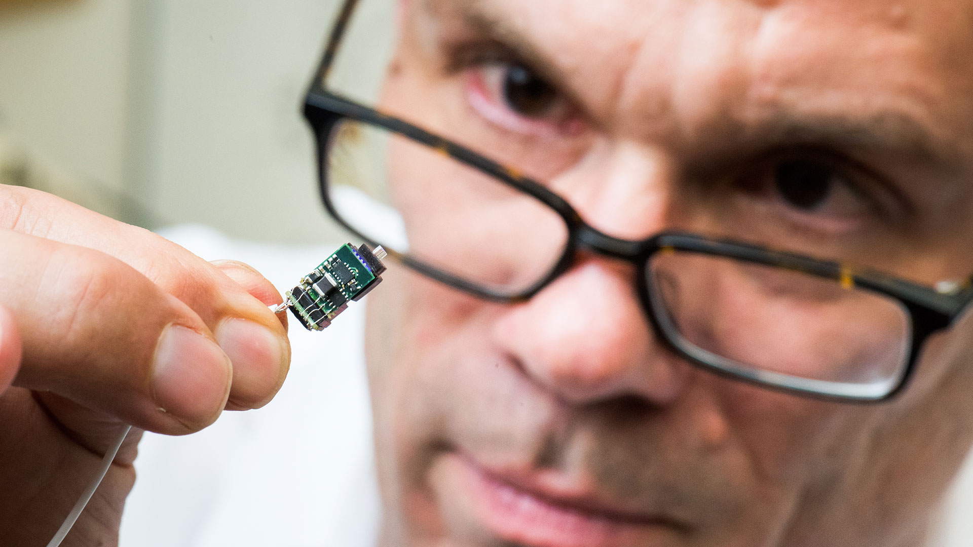 Fee examines mini microscope.