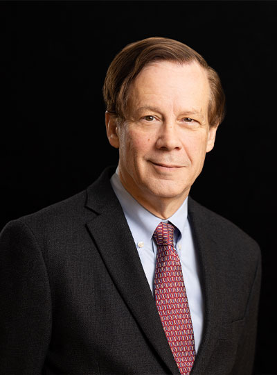 Portrait of Bob Desimone wearing a suit and tie. 